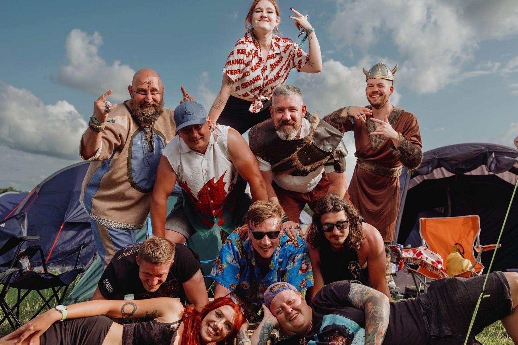 Festival-goers form a human pyramid at their campsite