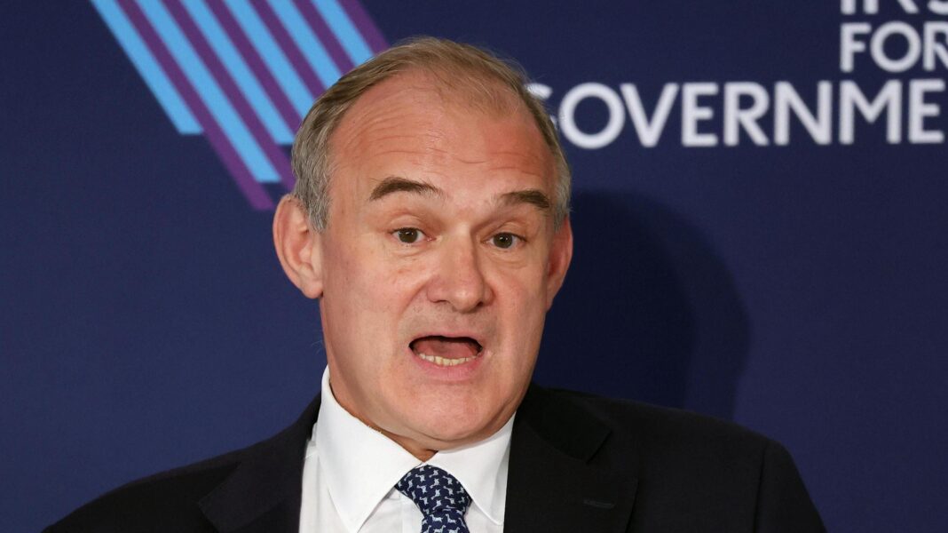 Burnham to fight next election on pledge to change voting system Ed Davey making a speech in a dark suit and blue tie against an Institute for Government backdrop