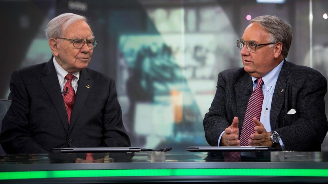 Warren Buffett listens as his son Howard Buffett speaks during an interview in New York on 22 October 2013.