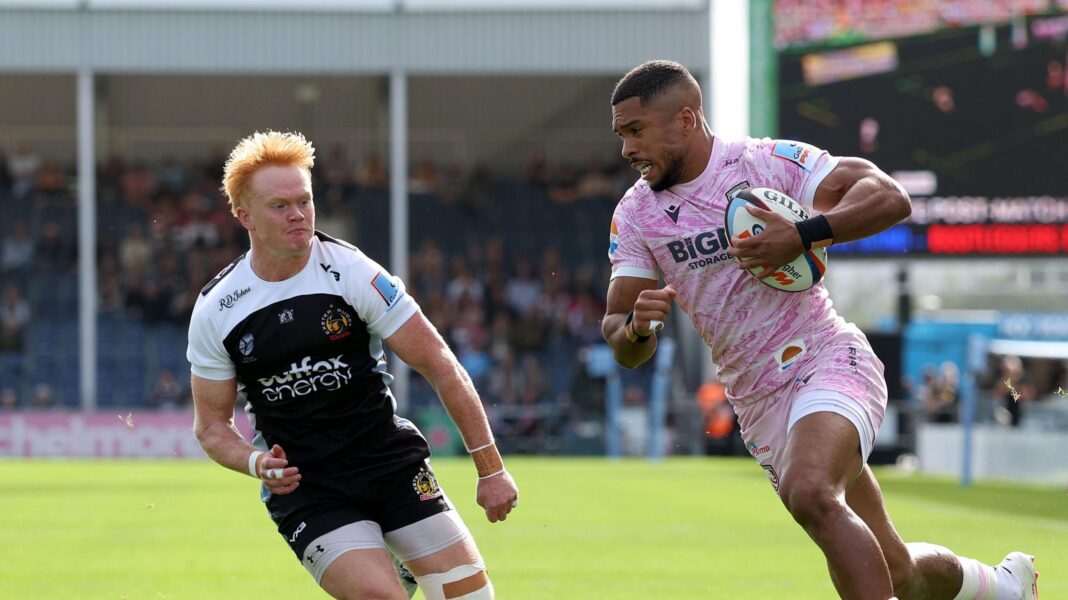 Ben Loader has the ball in his left hand on his way to scoring as Exeter player Ben Hammersley (left) tries to get back to stop him