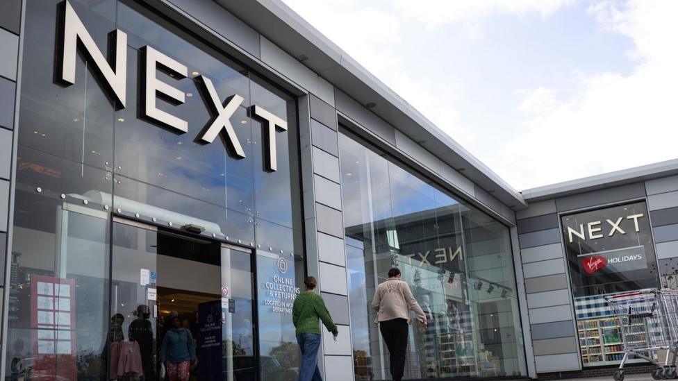 A next storefront with people outside it.