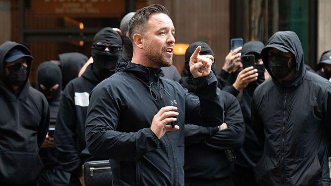 Danny Tommo, (Daniel Thomas) addresses the group of men outside the Daily Mail Offices at Associated Newspapers on September 9, 2026 in London, England. Leader of the self styled "Patriot Platform" Danny Tommo, (Daniel Thomas) led a group of men in balaclavas to the Daily Mail offices in South Kensington to peacefully protest against the paper's reporting of his Mother's details.