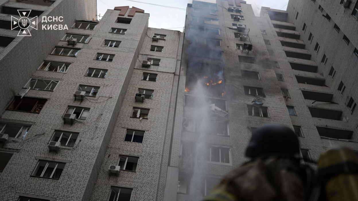 A firefighter looks at a burning multi-storey residential building after a Russian drone attack in Kyiv, Ukraine. Photo: 25 September 2026