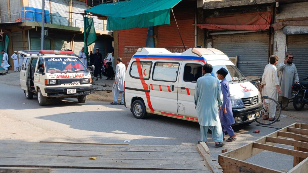 At least 16 killed after vehicle loaded with explosives rams into Pakistan mosque Two ambulances in the road near the scene of the blast
