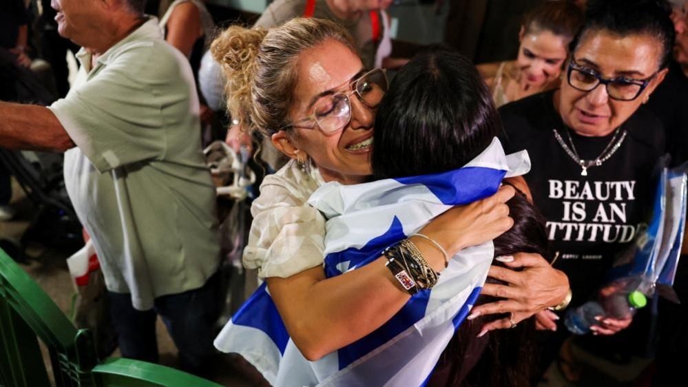 People hug each other after passengers from the diverted Flydubai flight arrive at Tel Aviv's airport on a repatriation flight. Photo: 30 September 2026