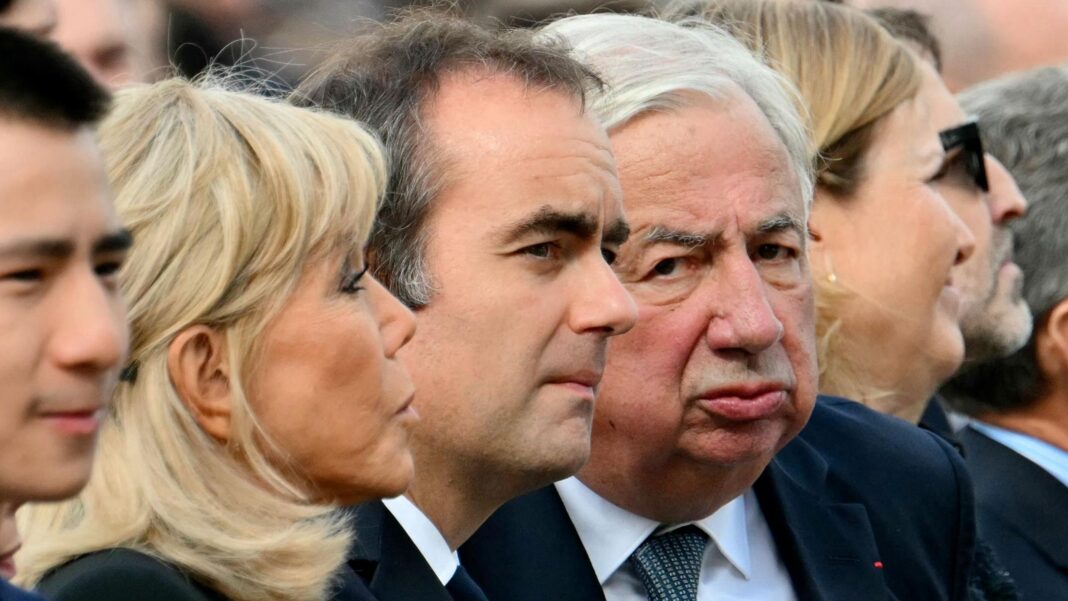 Pope praises young people’s ‘energy and commitment’ at huge open-air Mass in Paris Brigitte Macron, Sebastien Lecornu and Gerard Larcher sit together and stare in different directions as they attend the outdoor mass in the centre of Paris.