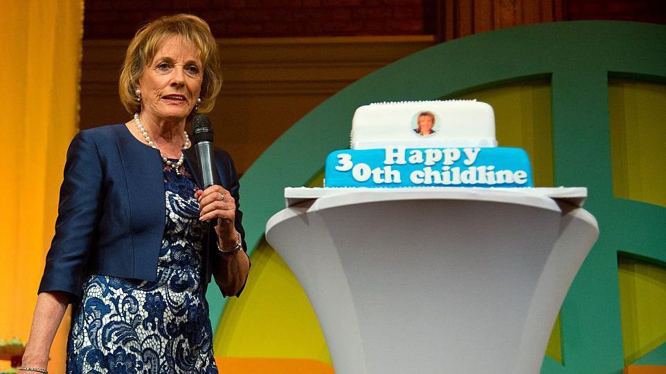 Dame Esther Rantzen with a 30th anniversary of Childline cake.  The message on the cake says Happy 30th Childline.