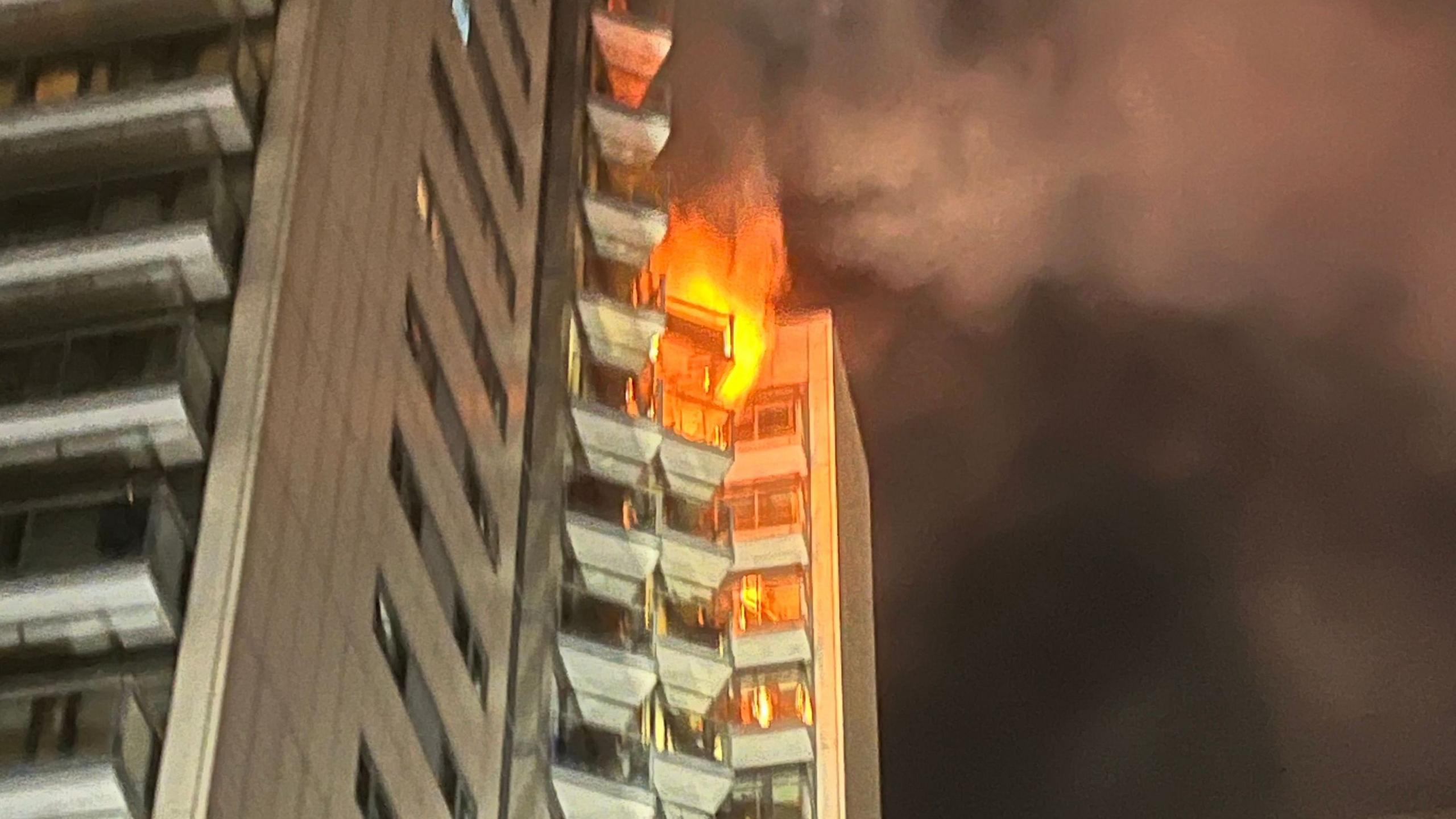 A tower block partly in flames