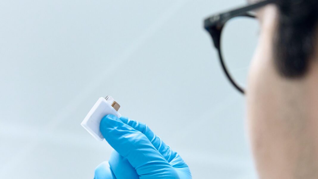 A LeydenJar worker holds up a battery that uses the company's nano-coating