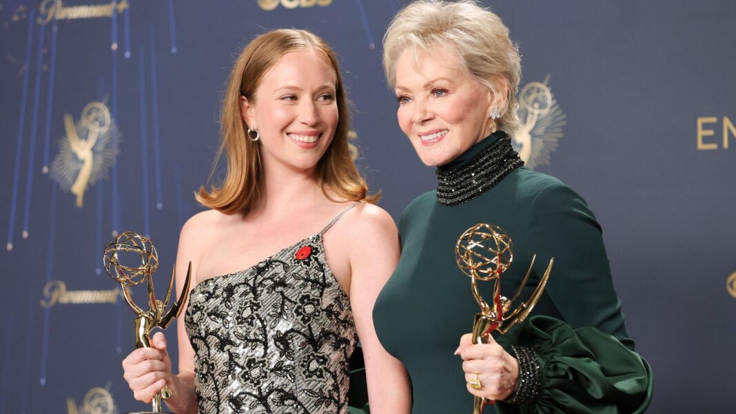 Hannah Einbinder and Jean Smart, winners of outstanding supporting actress in a comedy Series and lead actress in a comedy series for Hacks at last year's Emmys - Einbinder is wearing an off-the-shoulder silver and black dress, while Smart is wearing a forest green high-necked dress
