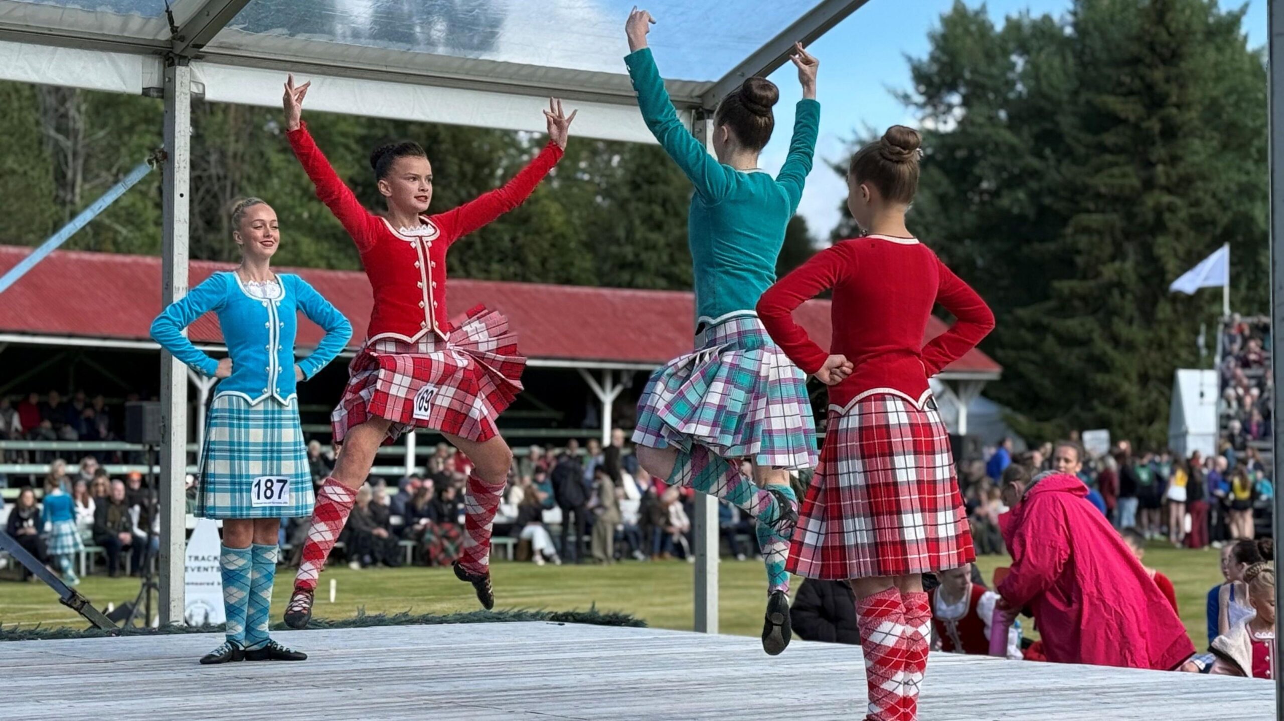 four highland dancers on a stage