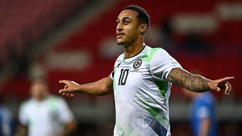 Forward Adam Idah celebrates with his arms outstretched after scoring for the Republic of Ireland against Israel