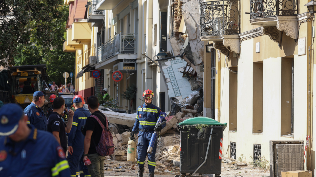 Street where the explosion happened, showing the front of the collapsed building with emergency crews working at the site