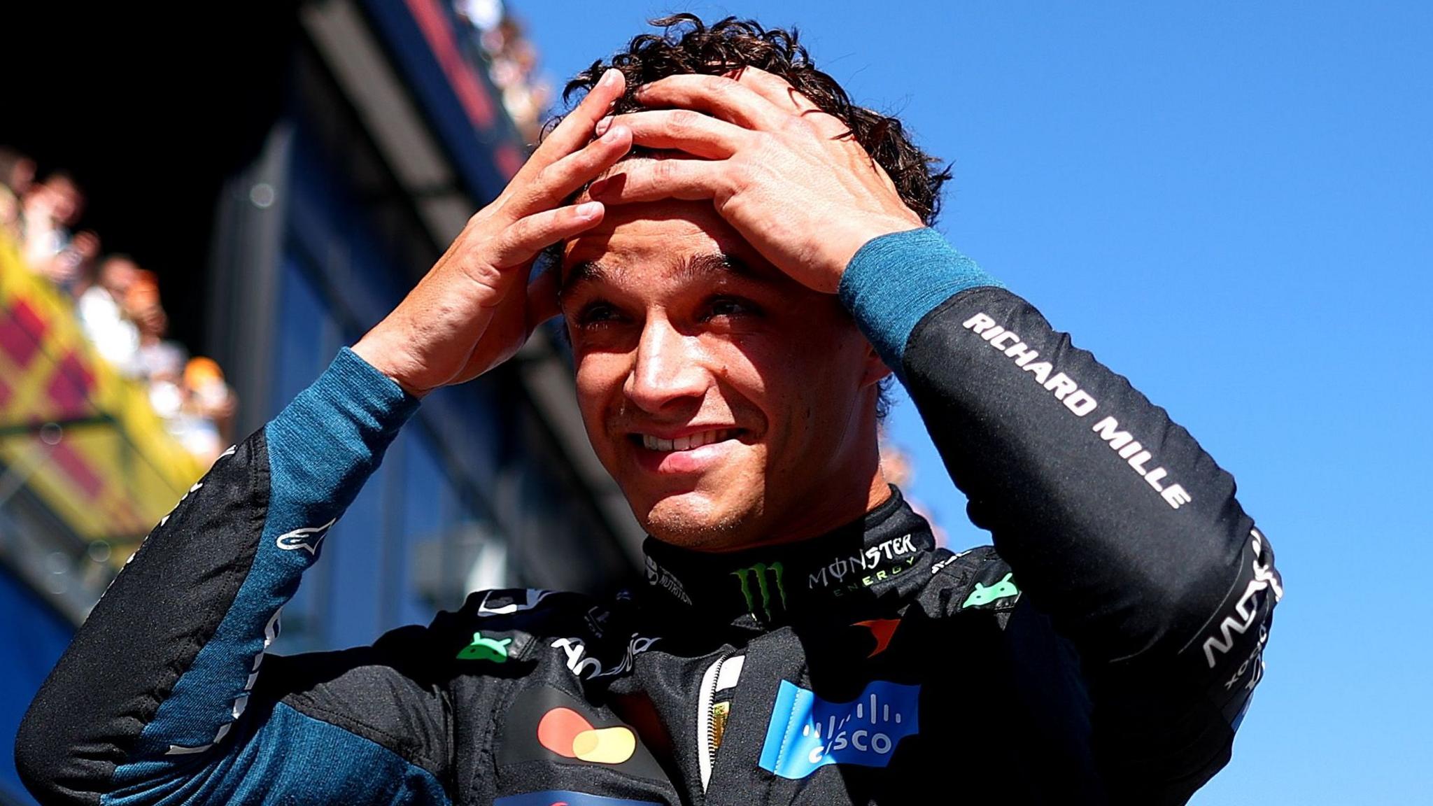 Lando Norris has both hands on his head and appears shocked after taking pole position for the Spanish Grand Prix