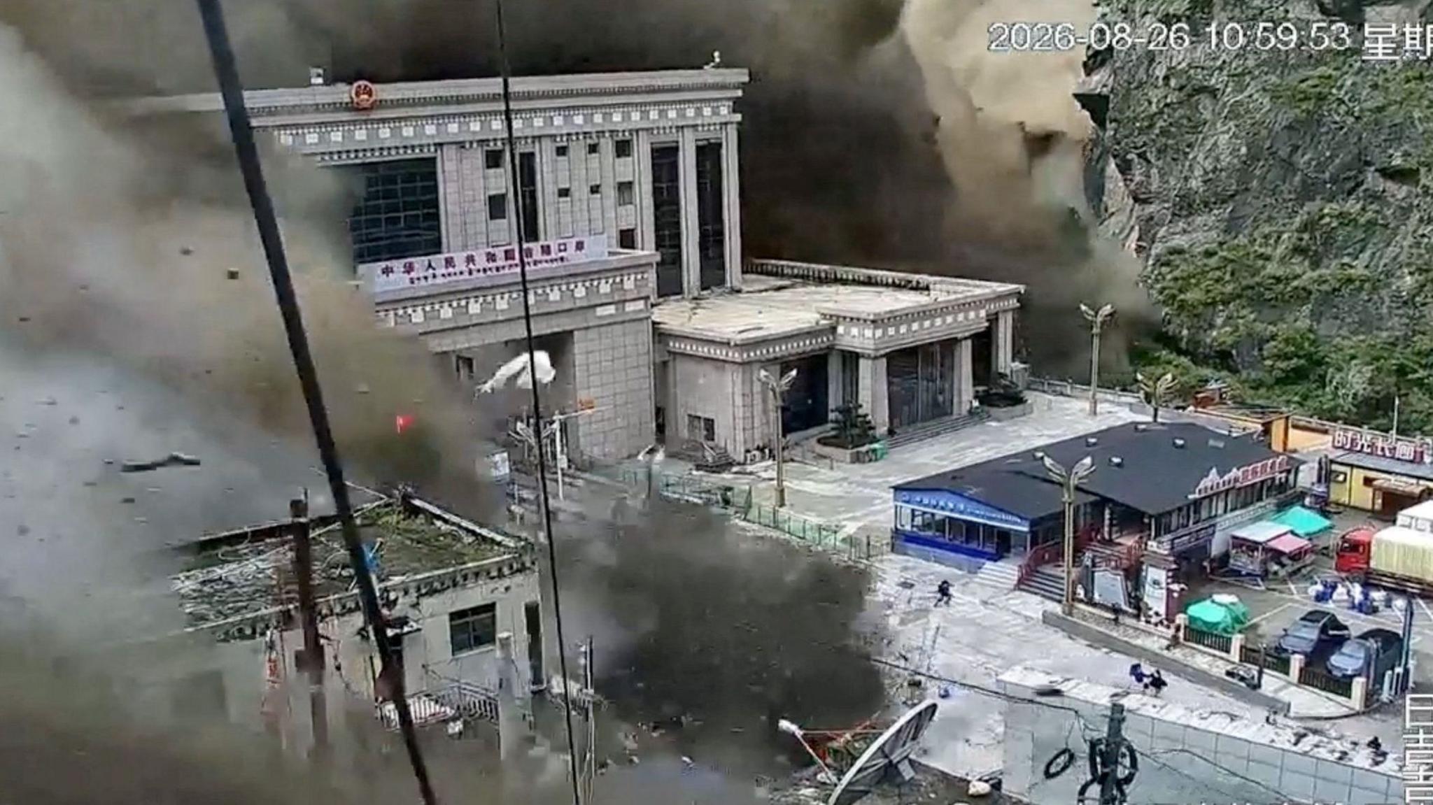 CCTV footage shows people fleeing as a wall of mud and water destroys buildings at the Nepal-China border in Gyirong, Tibet, China, on August 26, 2026.