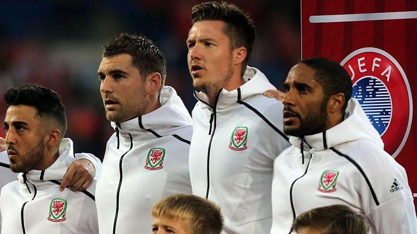 Neil Taylor, Sam Vokes, Wayne Hennessey and Ashley Williams lineup to sing the Welsh national anthem.