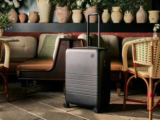 A black suitcase next to bistro tables