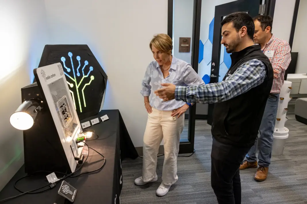 Noble Carbon will show how it’s making EV charger installs painless at TechCrunch Disrupt A man and woman talking before an electrical device.