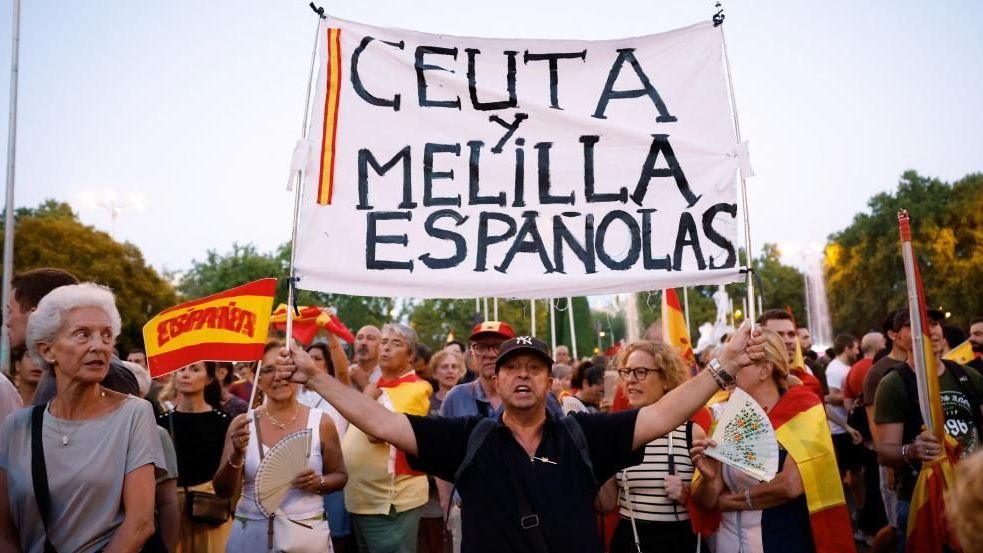 Embattled Spanish PM Sánchez insists no prior warnings before Ceuta crisis Protesters hold flags and a sign during a demonstration in support of residents of Spain's North African enclave of Ceuta following recent mass crossings of migrants from Morocco, in Madrid, Spain, September 2, 2026.