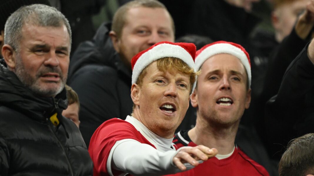 Manchester United fans wearing Santa hats at a match on 21 December 2026