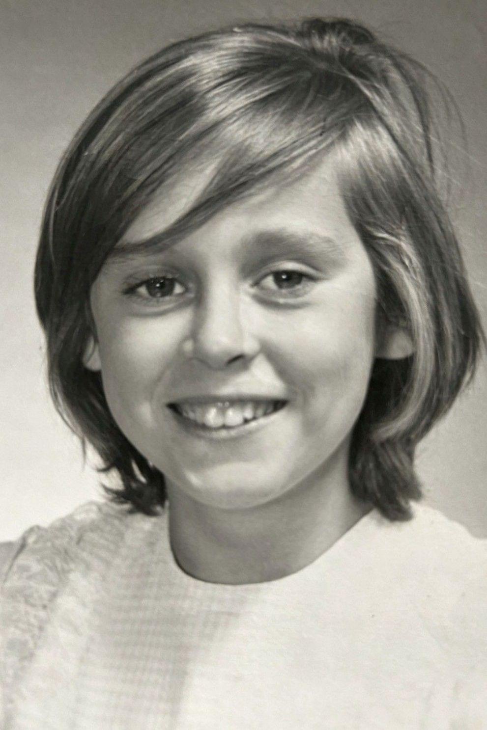 A black and white photo of Janett as a child, taken one year after the disaster. She has a bob and a fringe and is wearing a pale coloured top