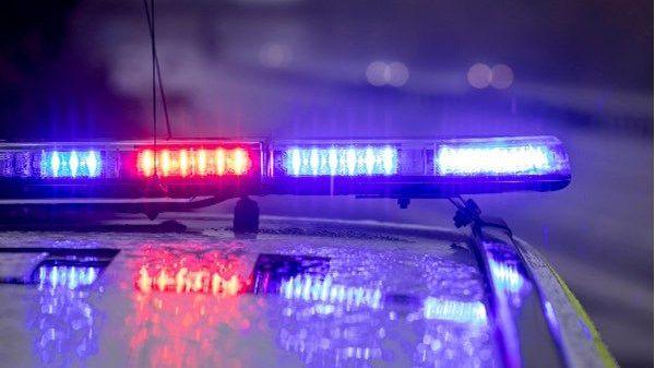 Two killed as car hits group of cyclists Flashing police lights.