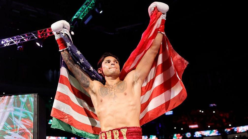 Ryan Garcia celebrates with a half-American and half-Mexican flag