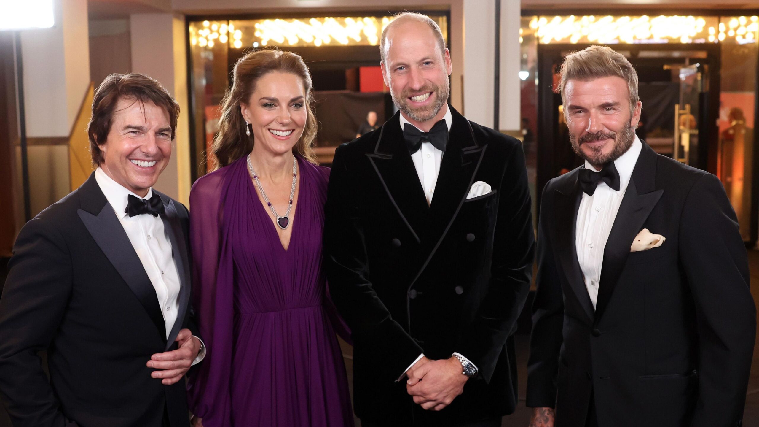 Tom Cruise, the Princess and Prince of Wales and David Beckham standing and posing in a row