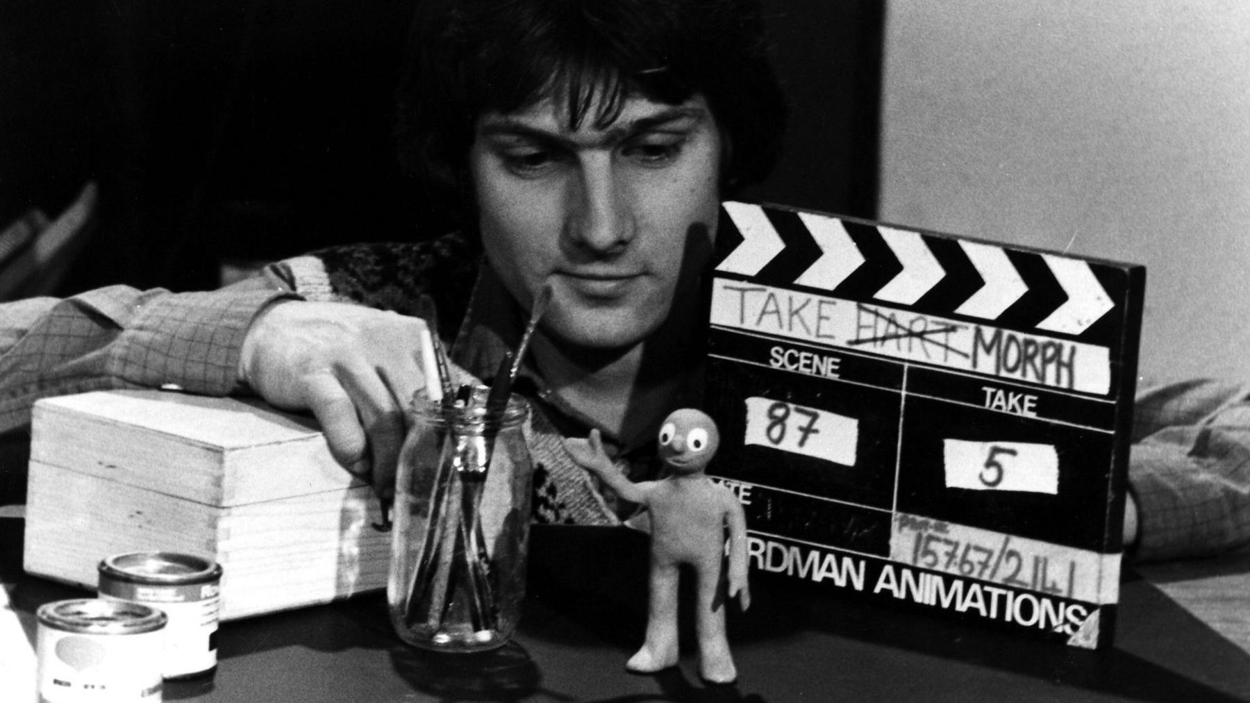 David Sproxton with a model of Morph and a clapperboard on the set of Take Hart in 1976