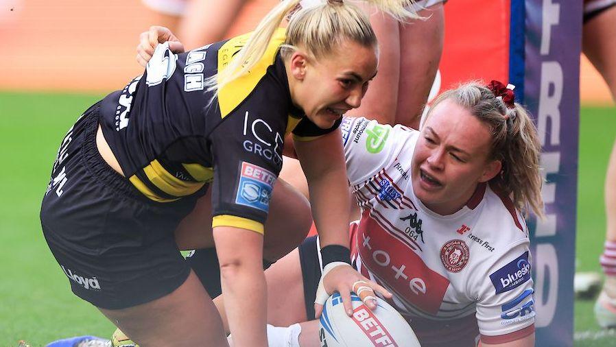 Sinead Peach celebrates after scoring from close range for York as Wigan's Mary Coleman looks on from the ground