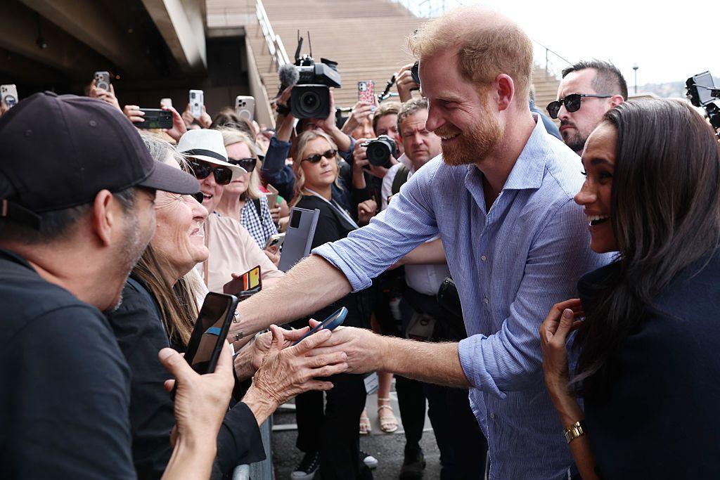 Harry and Meghan interacting with crowd.