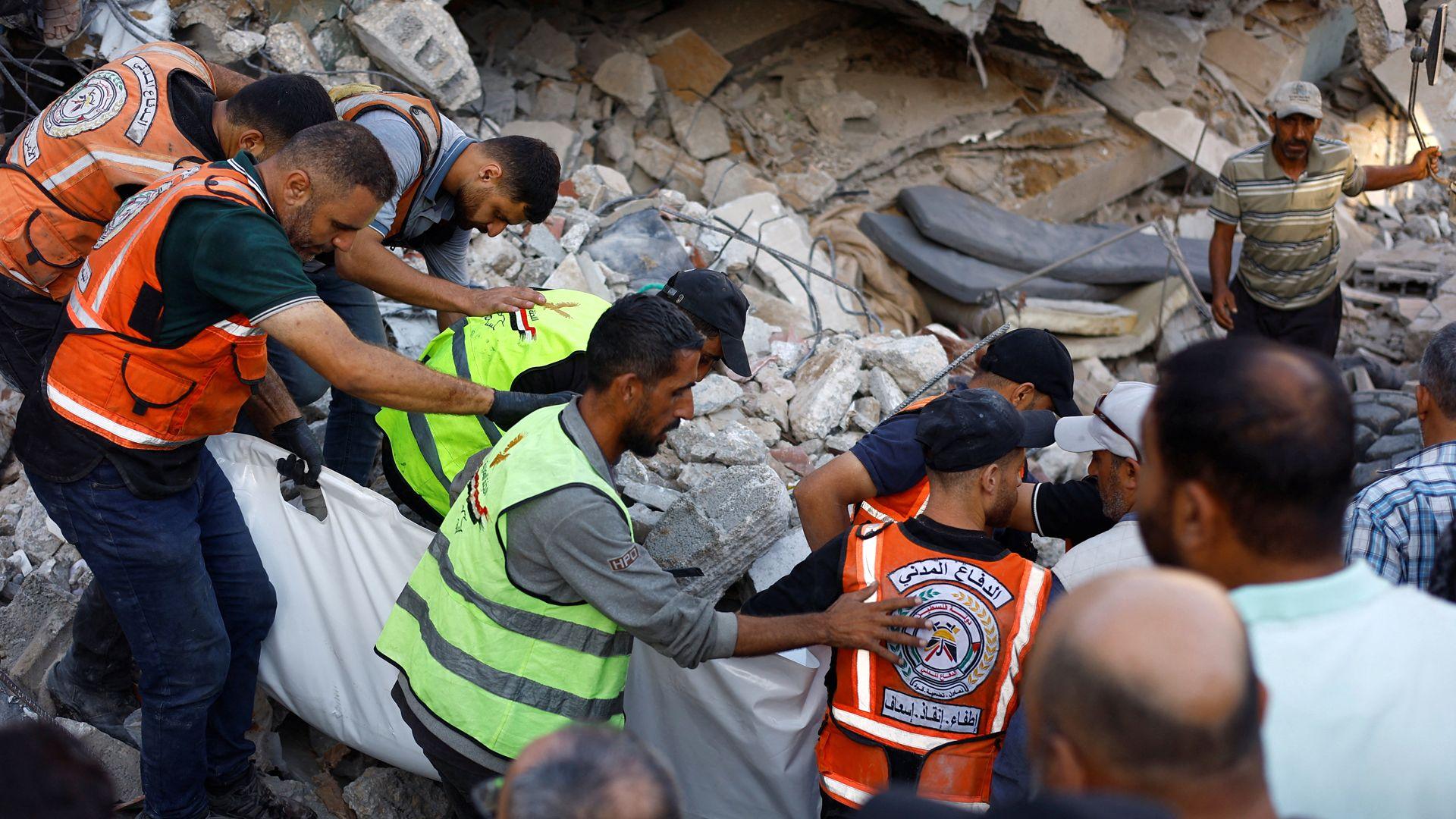 Gaza Civil Defence first responders attempt to rescue people trapped beneath the rubble of a war-damaged residential building that collapsed in Gaza City (16 September 2026)