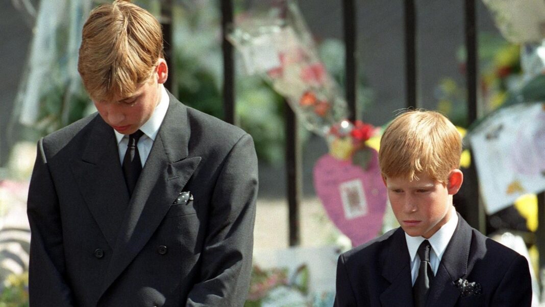 Prince William and Prince Harry bow their heads as their mother's coffin leaves her funeral service
