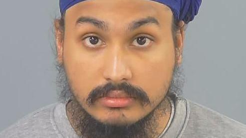 Custody photograph of Vickrum Digwa wearing a turban and grey sweatshirt.