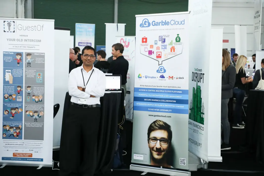 Person stands in front of GarbleCloud exhibit table in the Expo Hall at TechCrunch Disrupt 2017 in SF