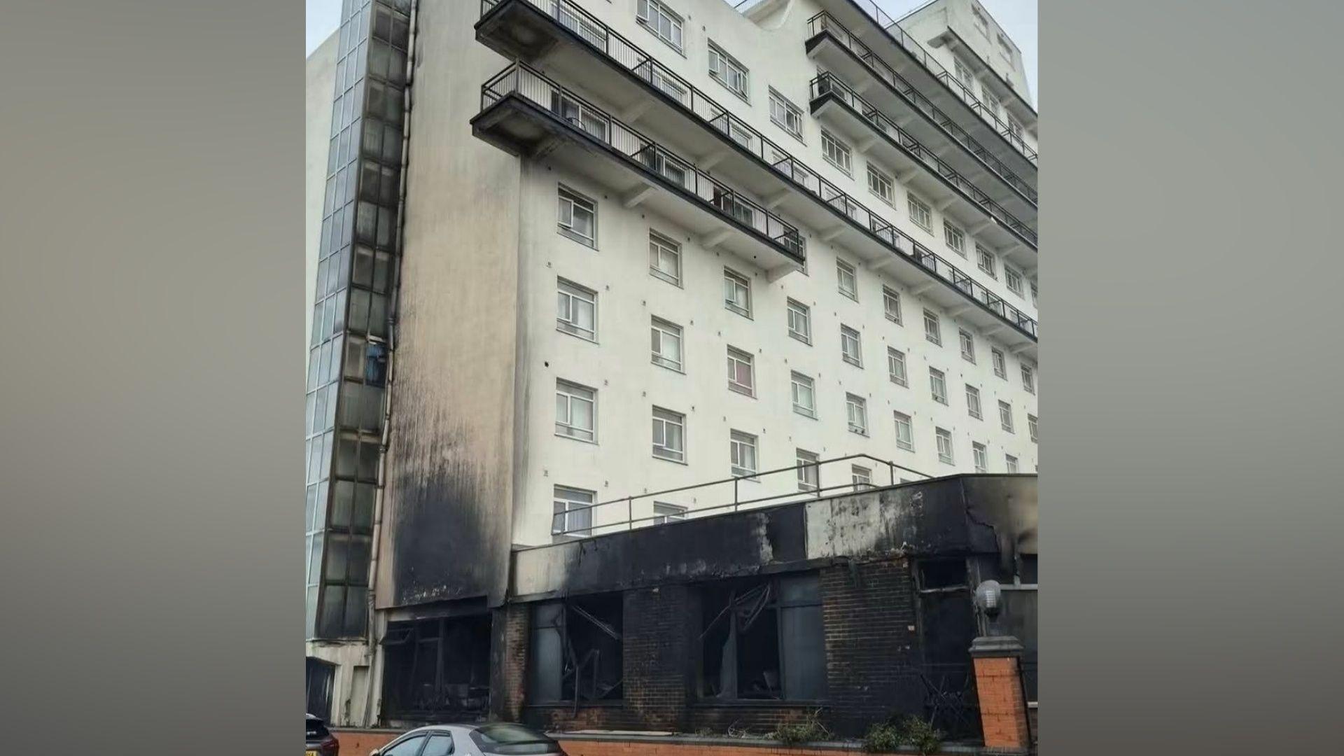 The front of a hotel damaged by fire.