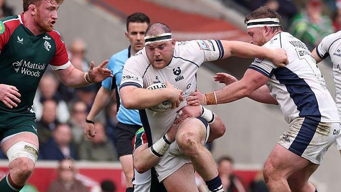 George Kloska runs while tackled around the waist, carrying the ball, during a match for Bristol last season