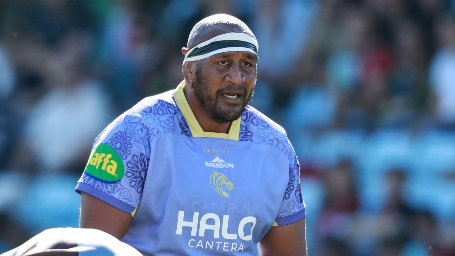 Mako Vunipola stands on the pitch wearing blue Leicester Tigers kit looking straight ahead during a Prem Rugby Cup match