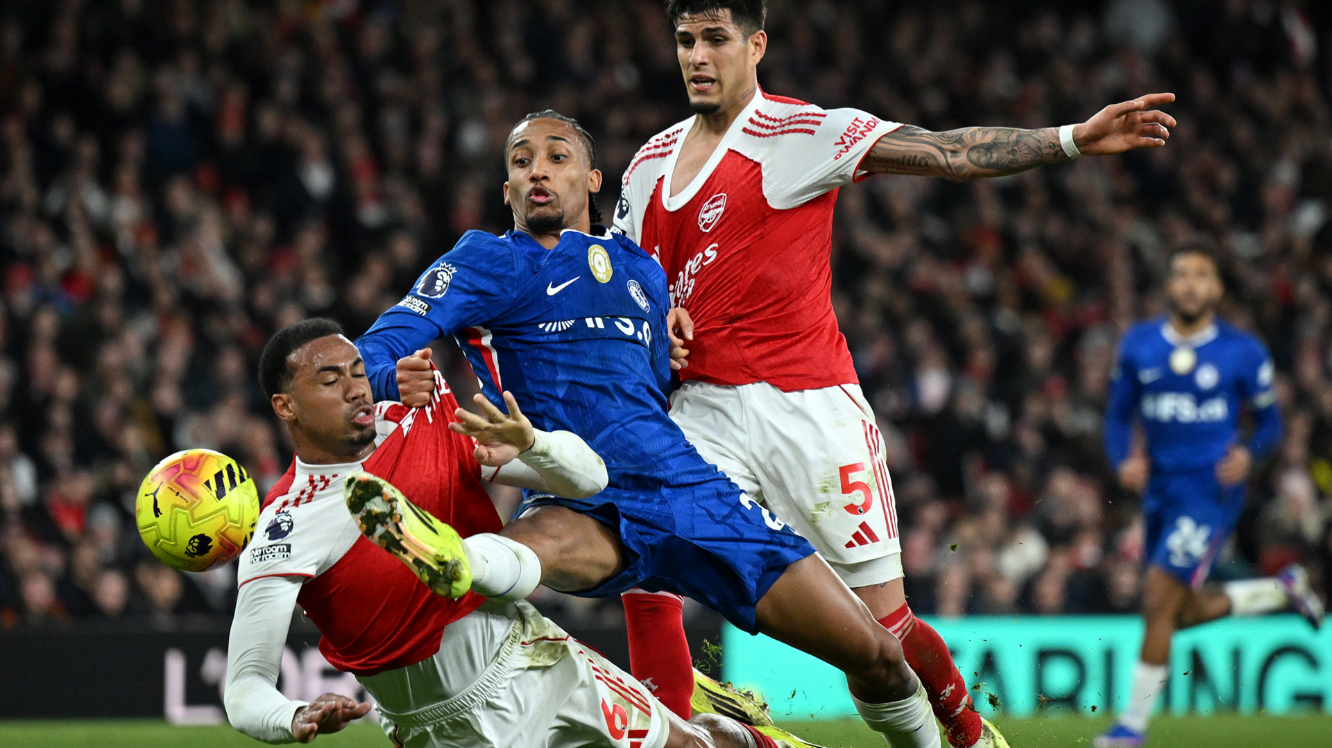 Arsenal players Gabriel and Piero Hincapie fight for the ball with Chelsea's Joao Pedro