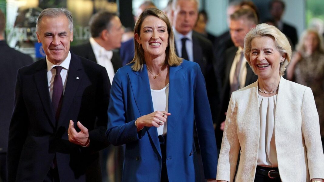 EU chief backs plan for Canada to become ‘associate member’ A smiling Mark Carney, wearing a suit, walks alongside European Parliament President Roberta Metsola and Ursula von der Leyen at the European Parliament