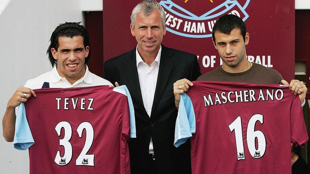 Carlos Tevez and Javier Mascherano, either side of manager Alan Pardew, hold up West Ham shirts