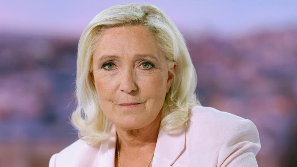French far-right leader Le Pen reacts on TV after her appeal trial verdict