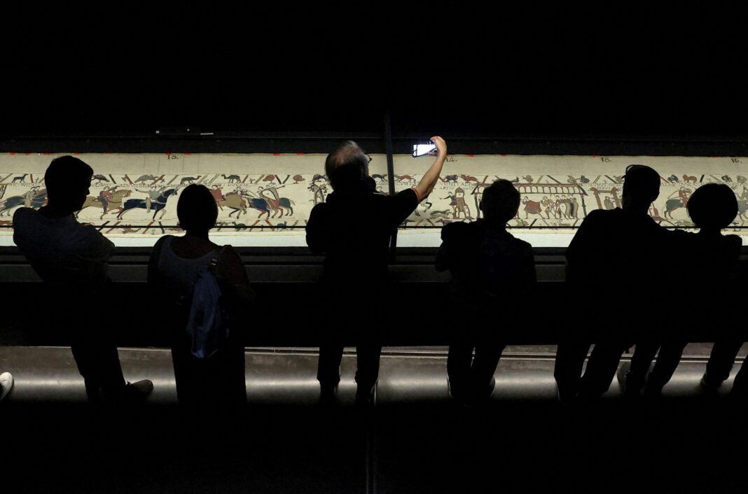 British Museum bans visitors from photographing Bayeux Tapestry Visitors view an illuminated Bayeux Tapestry as it is displayed in a darkened exhibition room at the British Museum in London.