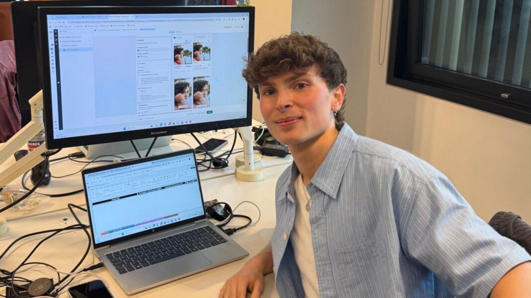 New job fresh out of uni? Here’s how we survived the first few days Oliver is looking at the camera smiling. He is sat at his work desk.