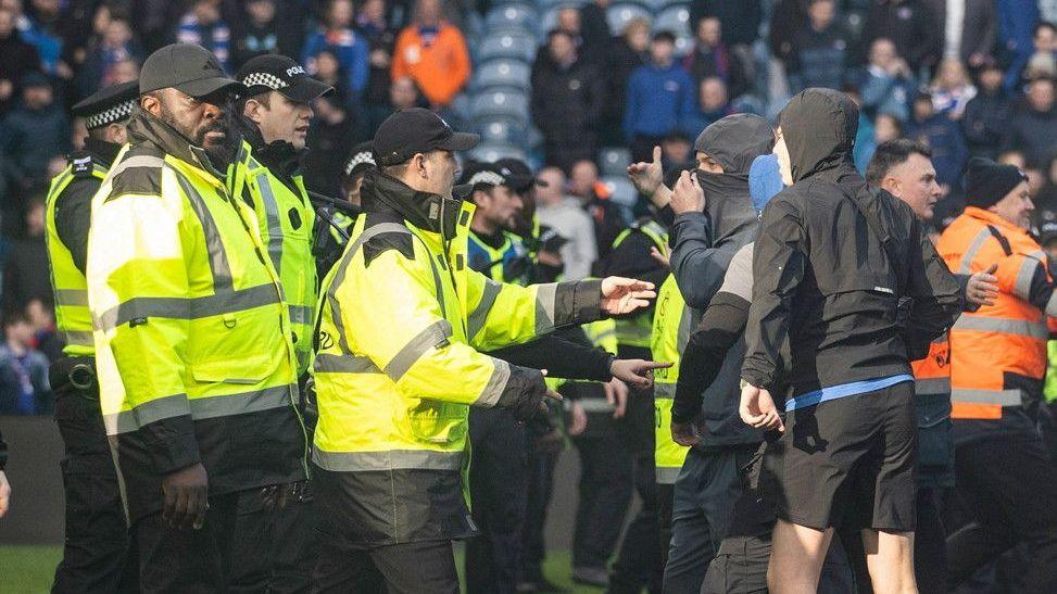 No away fans for Old Firm games this season after agreement reached Police and stewards had to intervene as fans stormed the Ibrox pitch on 8 March