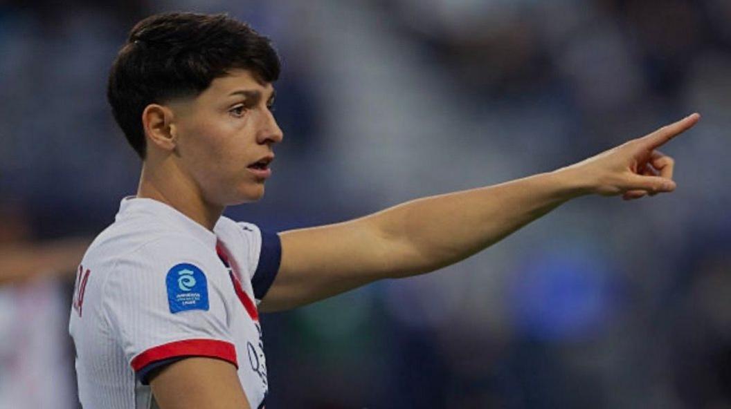 Arsenal sign France defender De Almeida from PSG Elisa de Almeida, wearing a white and blue Paris St-Germain kit, points at something during a match
