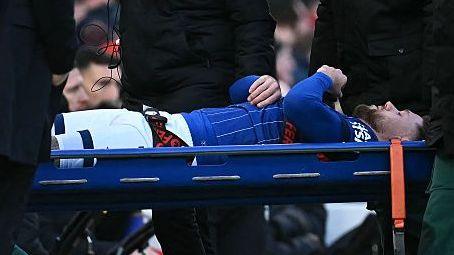 Wes Burns is carried off after injuring his knee playing for Ipswich
