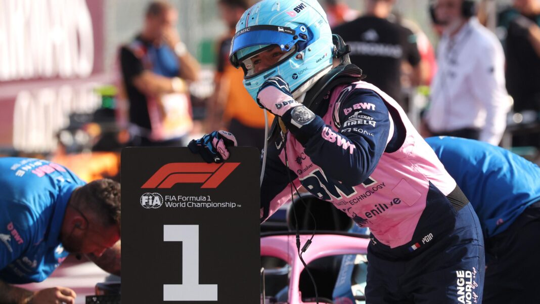 Alpine's Pierre Gasly poses with a picture of the '1' board after taking pole position at the Italian Grand Prix