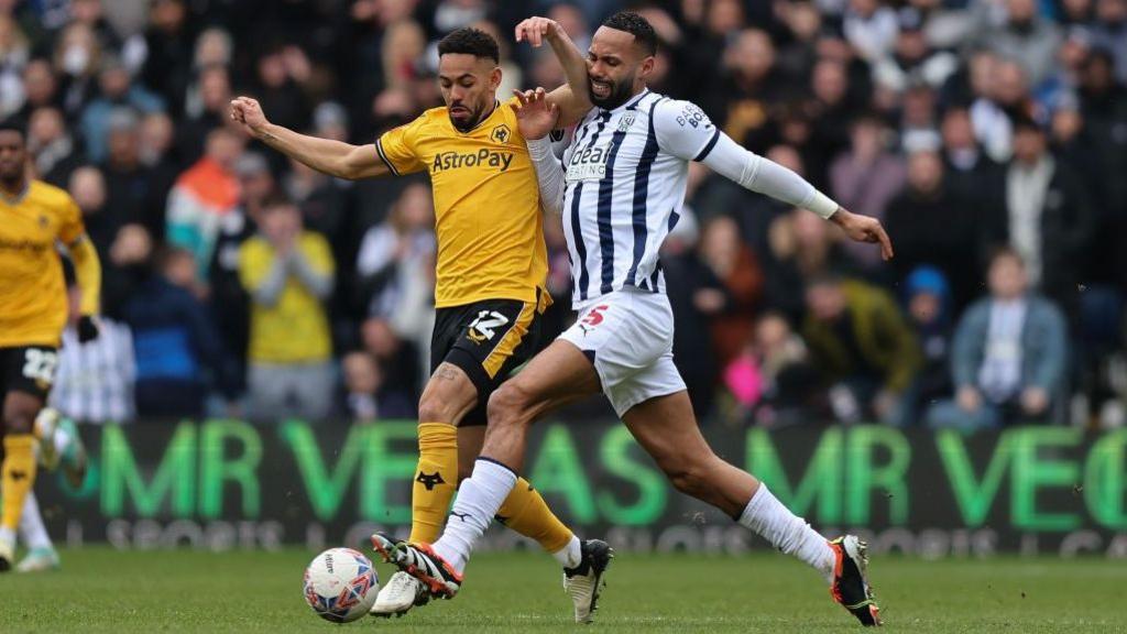 West Brom's Kyle Bartley and Matheus Cunha of Wolves battle for possession
