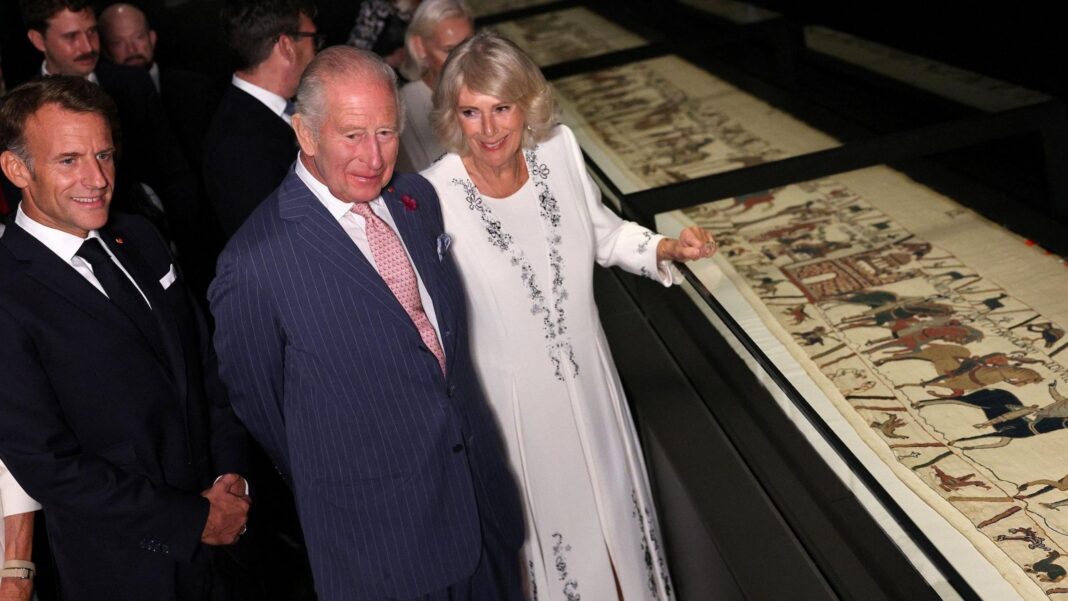 King Charles, President Macron and Queen Camilla looking at the Bayeux Tapestry